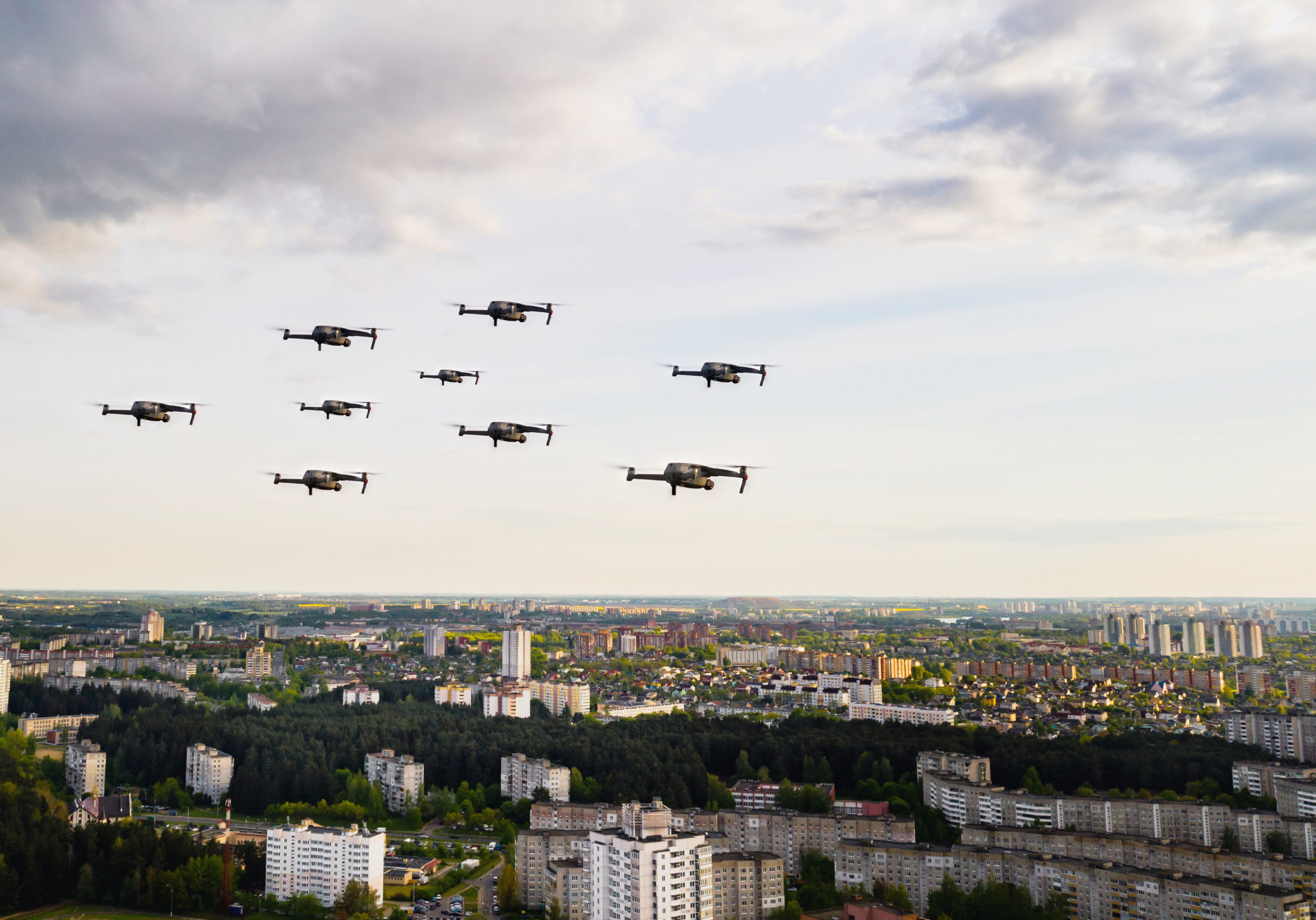 Drones flying over the houses of the city of Minsk. Urban landscape with drones flying over it.Quadrocopters fly over the city